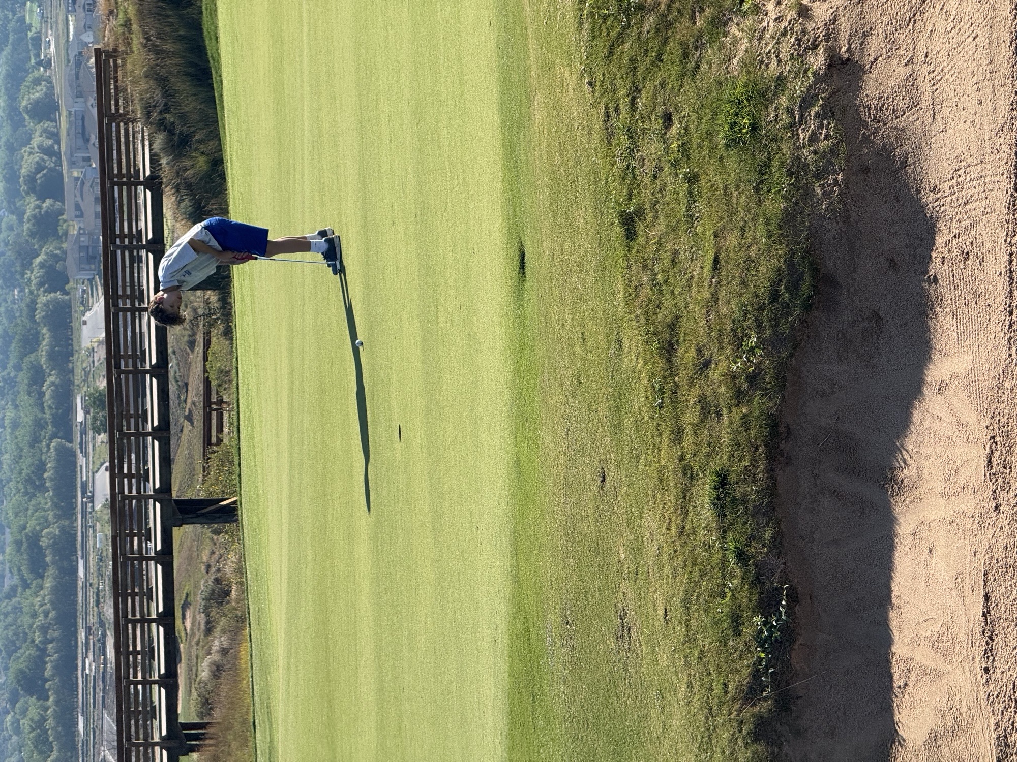 A poudre golfer makes a long putt. 