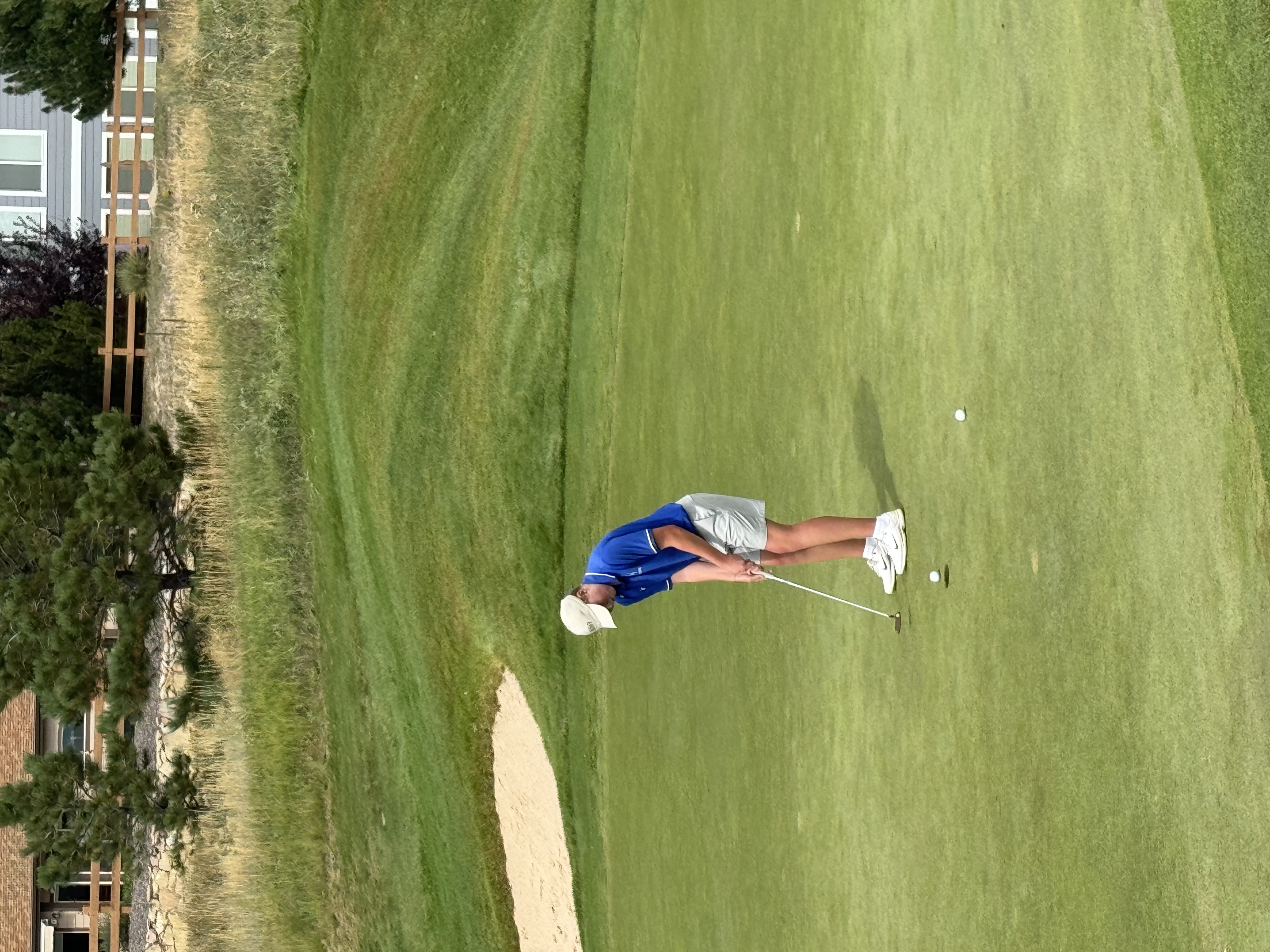 An Poudre golfer putts on a green