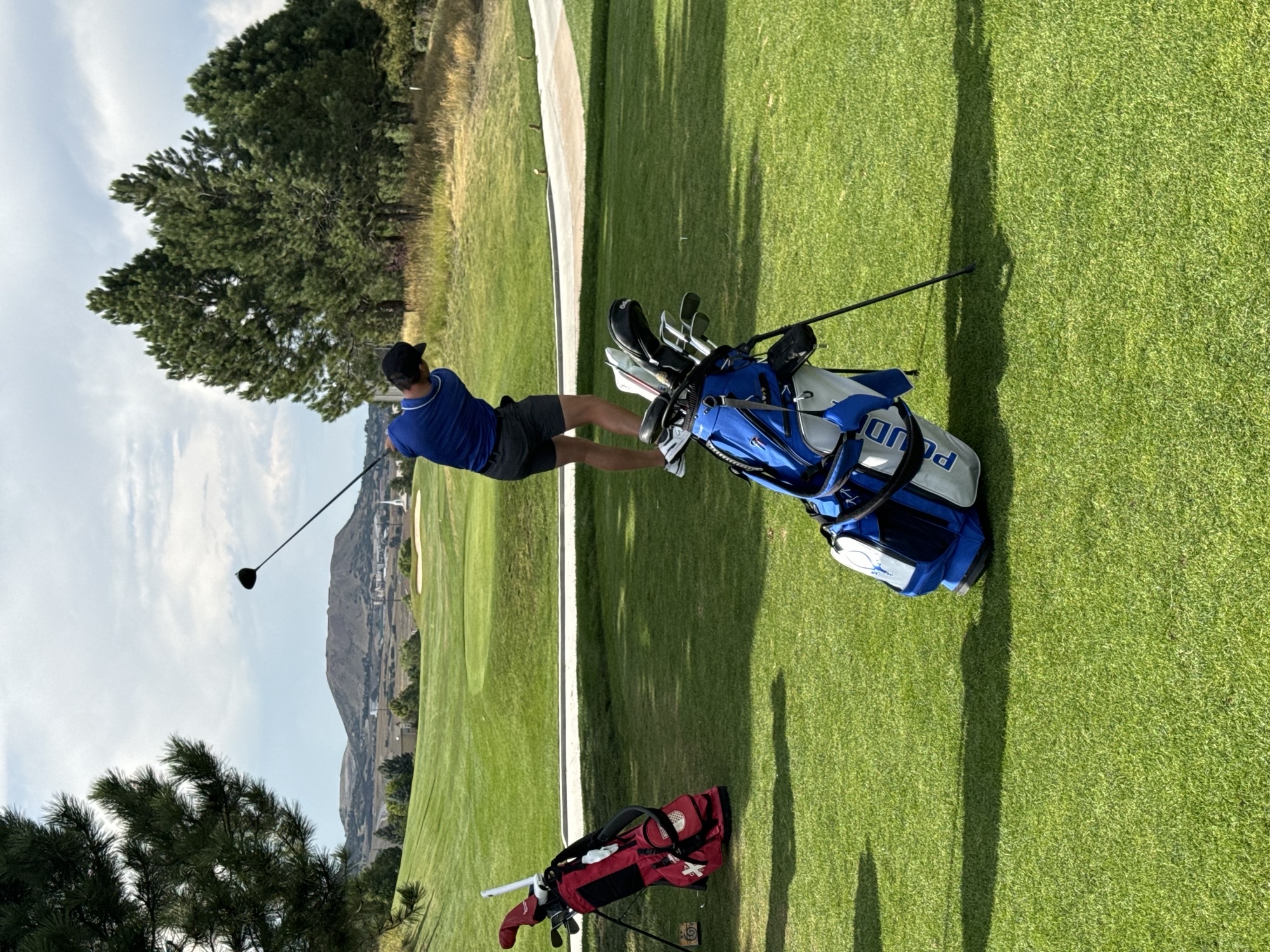 A Poudre boys golfer hits a powerful drive off of a tee box